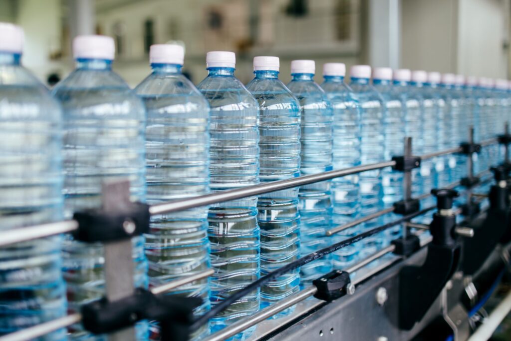 refillable plastic bottles on conveyor belt